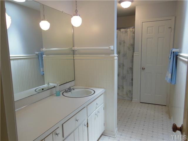 1115 Briardale Road Durham, NC 27712 - Photo 19 of 25 a bathroom with a granite countertop sink a toilet and shower