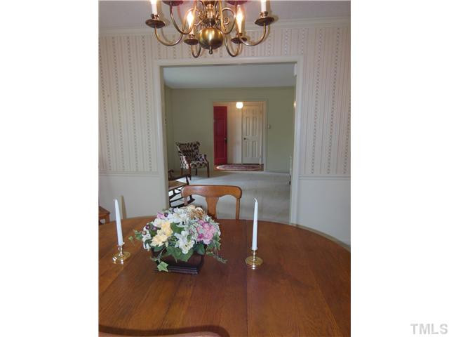 1115 Briardale Road Durham, NC 27712 - Photo 6 of 25 a view of a dining room with a chandelier and wooden floor