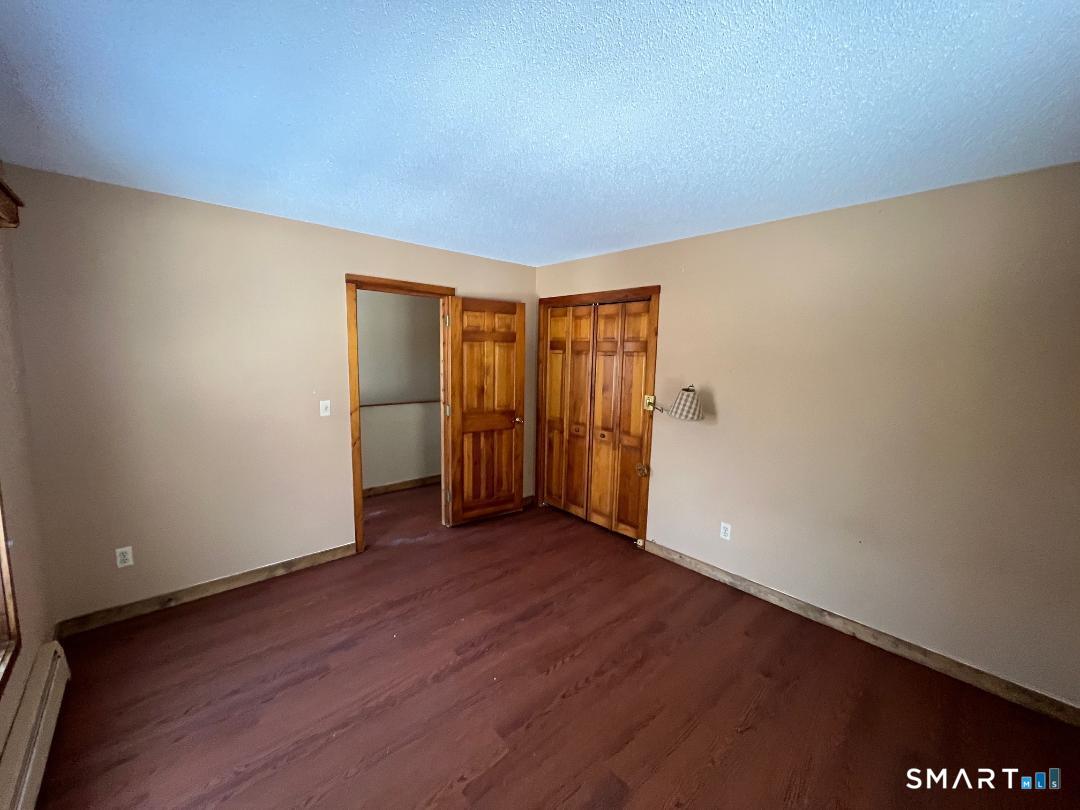 37 Potter School Road Willington, CT 06279 - Photo 27 of 31 an empty room with wooden floor and closet