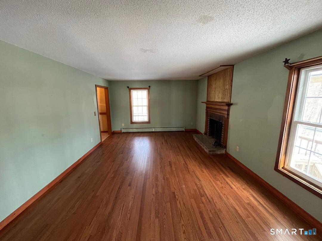 37 Potter School Road Willington, CT 06279 - Photo 4 of 31 an empty room with wooden floor and windows