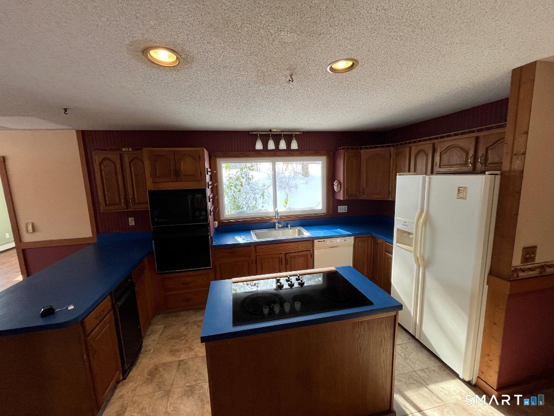 37 Potter School Road Willington, CT 06279 - Photo 9 of 31 a kitchen with a refrigerator and a stove