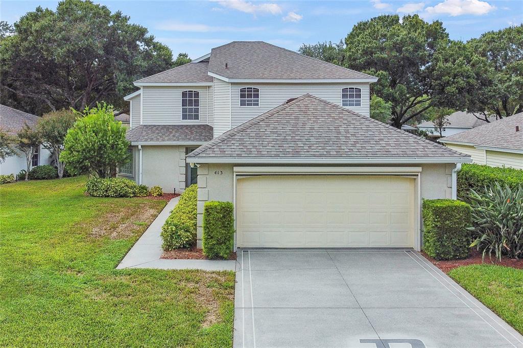 413 Baytree Boulevard Tavares, FL 32778 - Photo 1 of 1 a front view of a house with garden