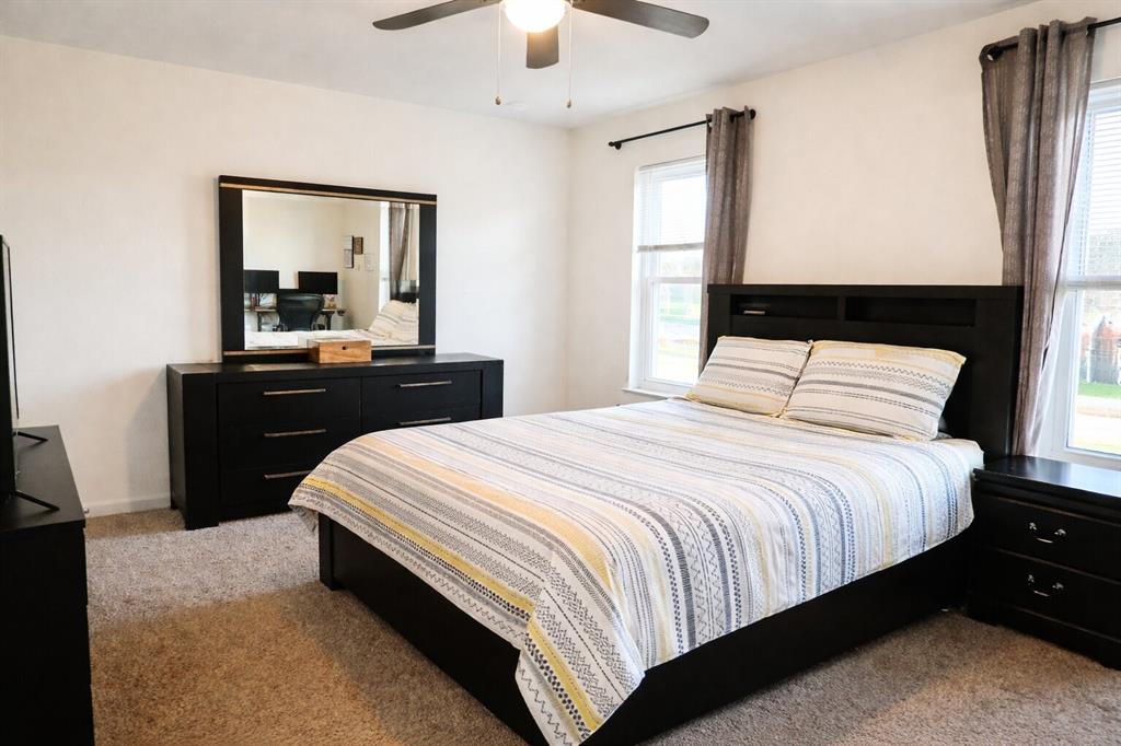 2223 Ridgedale Drive Carrollton, TX 75006 - Photo 11 of 27 a bedroom with a bed and a dresser