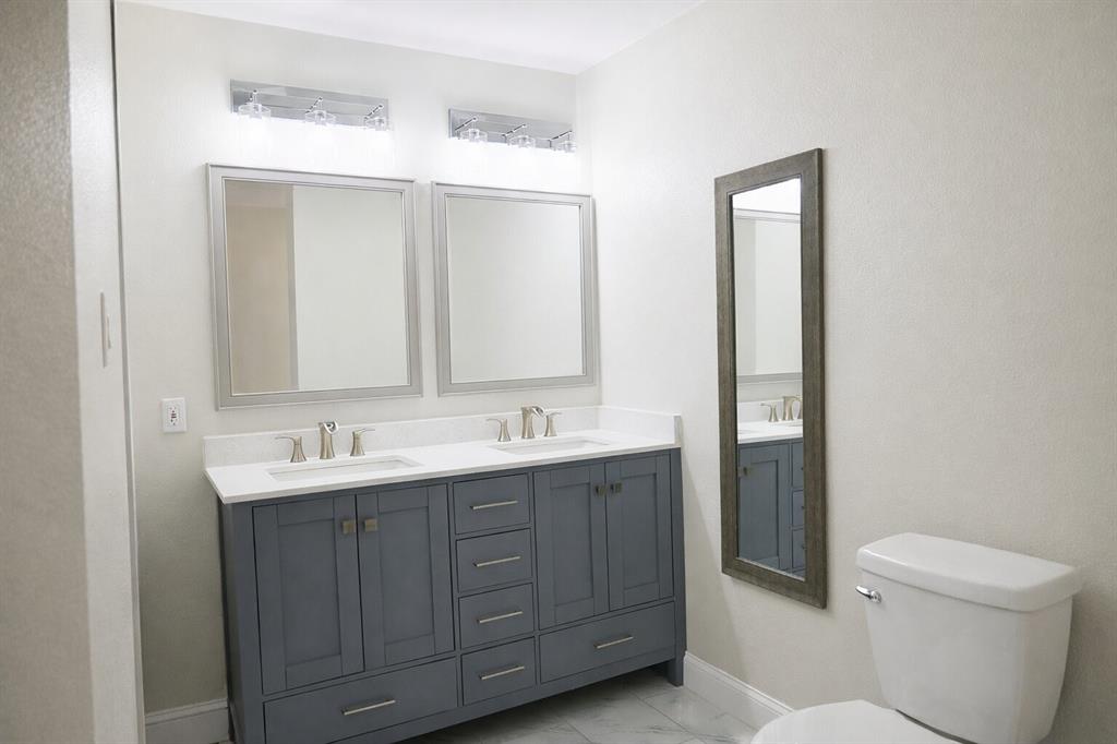 2223 Ridgedale Drive Carrollton, TX 75006 - Photo 14 of 27 a bathroom with a toilet sink and mirror
