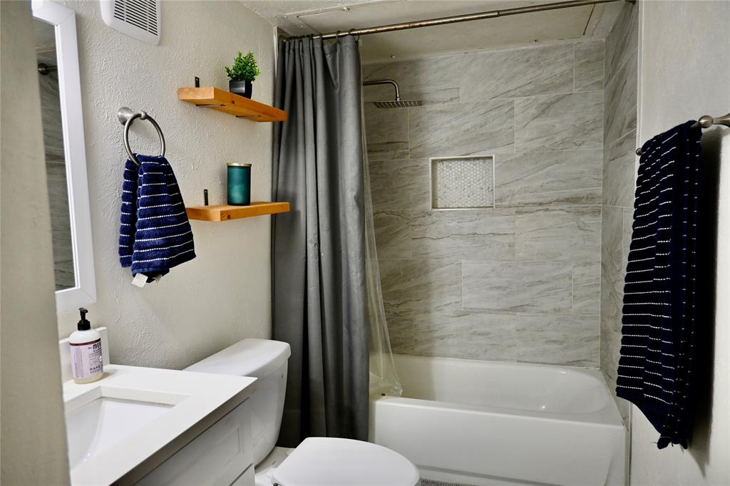 2223 Ridgedale Drive Carrollton, TX 75006 - Photo 18 of 27 a bathroom with a bathtub and shower