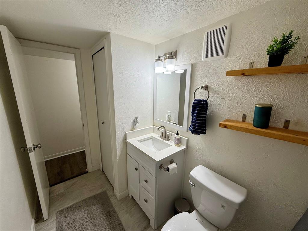 2223 Ridgedale Drive Carrollton, TX 75006 - Photo 21 of 27 a bathroom with a toilet sink and mirror