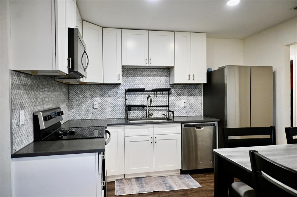 2223 Ridgedale Drive Carrollton, TX 75006 - Photo 5 of 27 a kitchen with granite countertop a refrigerator stove and sink