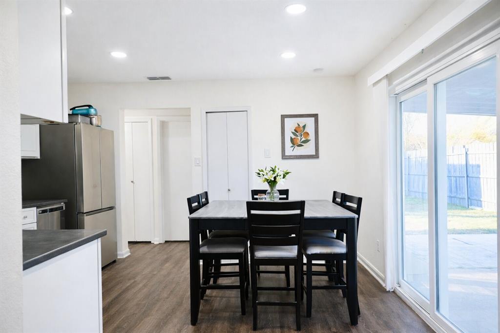2223 Ridgedale Drive Carrollton, TX 75006 - Photo 6 of 27 a view of a dining room with furniture and wooden floor