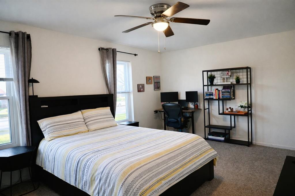 2223 Ridgedale Drive Carrollton, TX 75006 - Photo 8 of 27 a bedroom with a bed and a chandelier