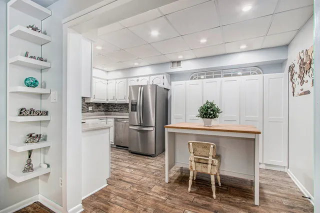a kitchen with refrigerator cabinets and wooden table