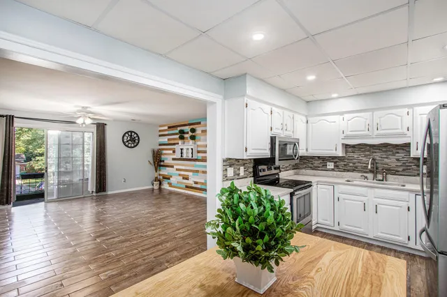 a kitchen with a refrigerator and a sink