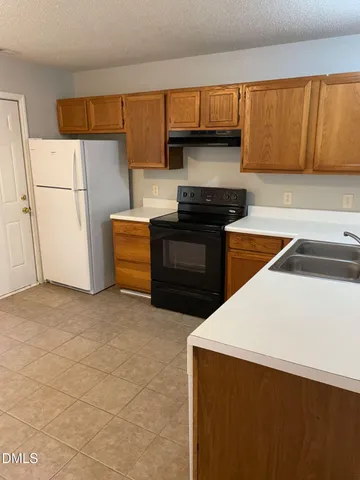 a kitchen with a refrigerator and a sink