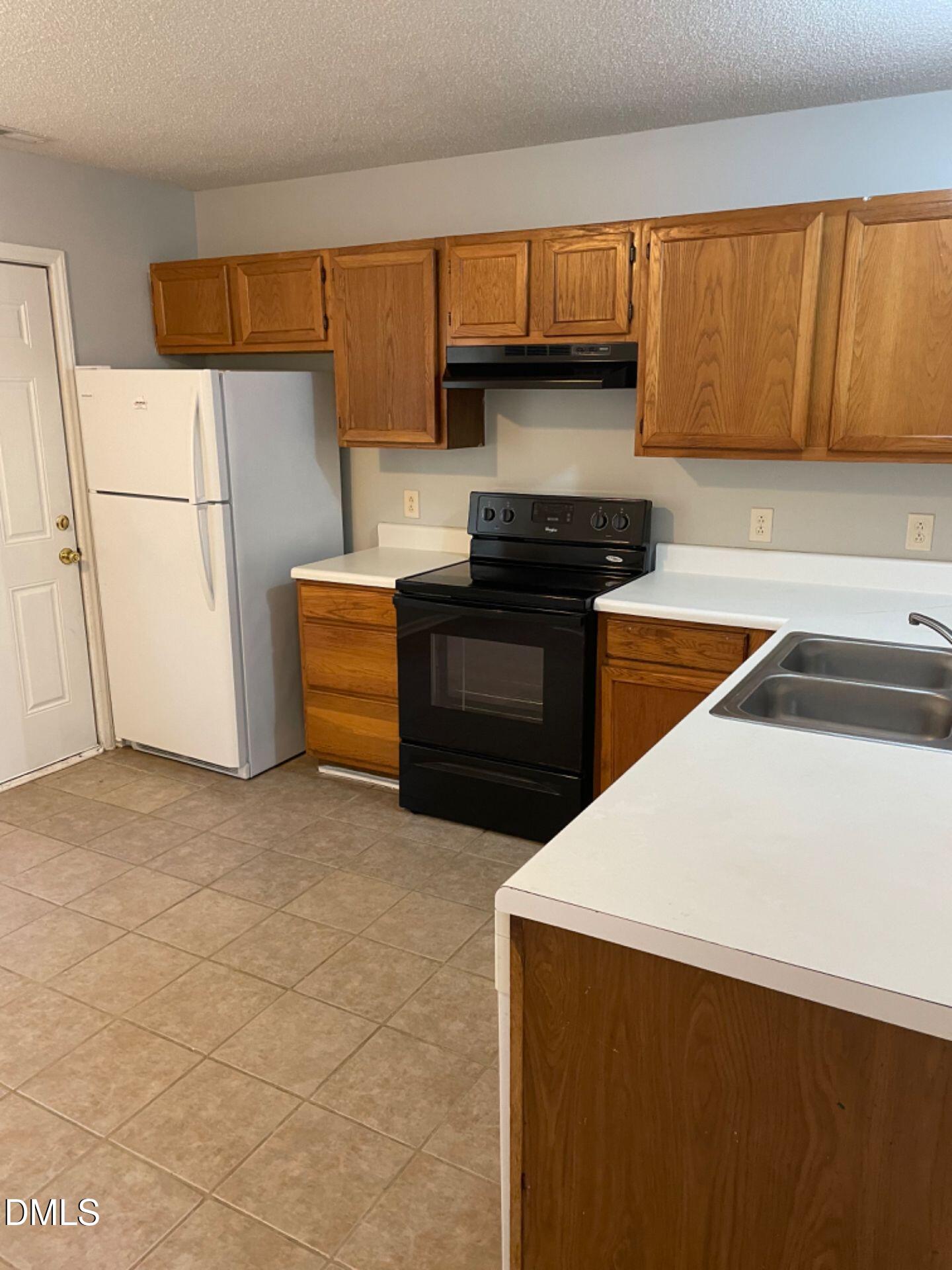 5515 Bringle Court Raleigh, NC 27610 - Photo 4 of 6 a kitchen with a refrigerator and a sink
