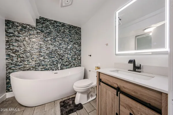 a bathroom with a bathtub and sink