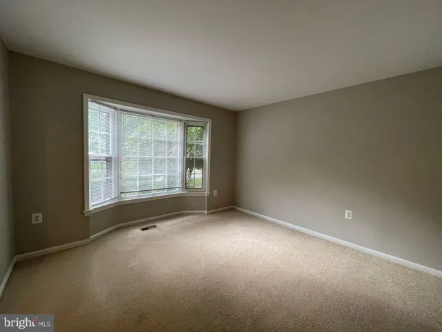 an empty room with a empty space and windows