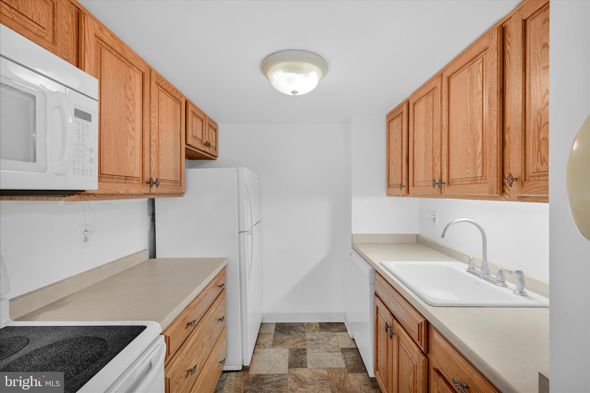 800 Avondale Road, Unit 6P Wallingford, PA 19086 - Photo 15 of 27 a kitchen with stainless steel appliances granite countertop a sink and a stove