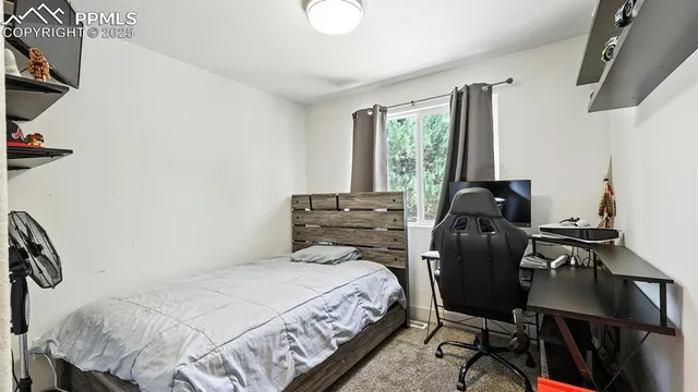 a bedroom with a bed and a desk
