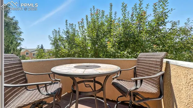 a view of a chairs and table in the patio