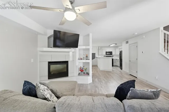 a living room with furniture and a fireplace