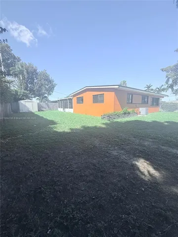 a view of an empty room with kitchen