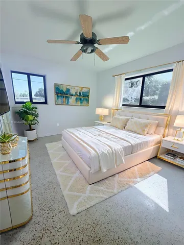 a bedroom with a large bed and a window