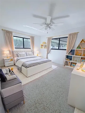 a spacious bedroom with a bed furniture and a window