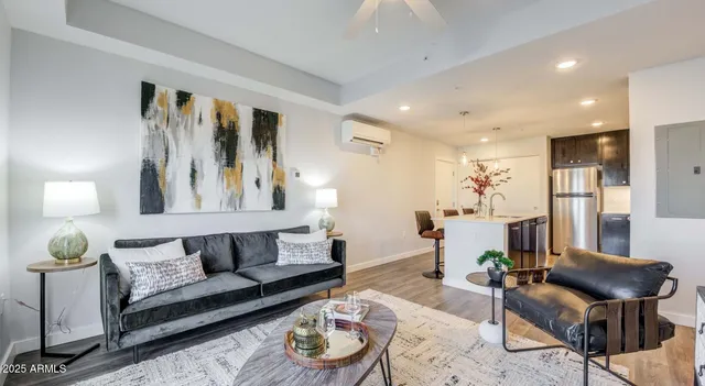 a living room with furniture and wooden floor