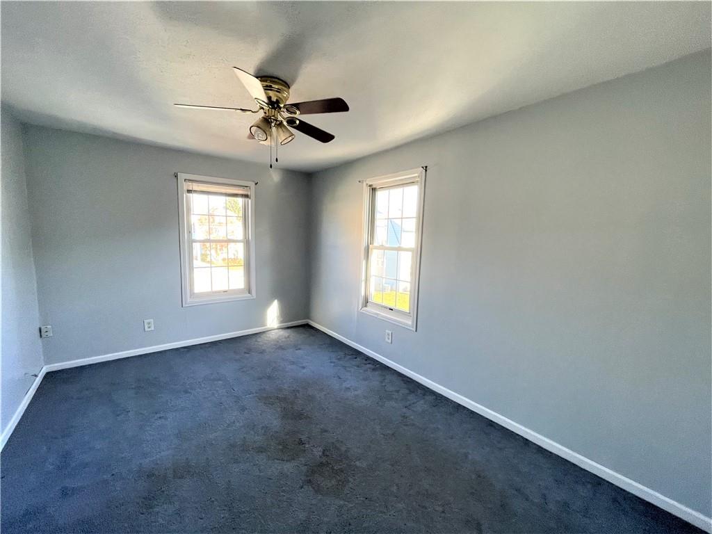 309 East Elizabeth Street New Castle, PA 16105 - Photo 11 of 13 an empty room with windows and fan