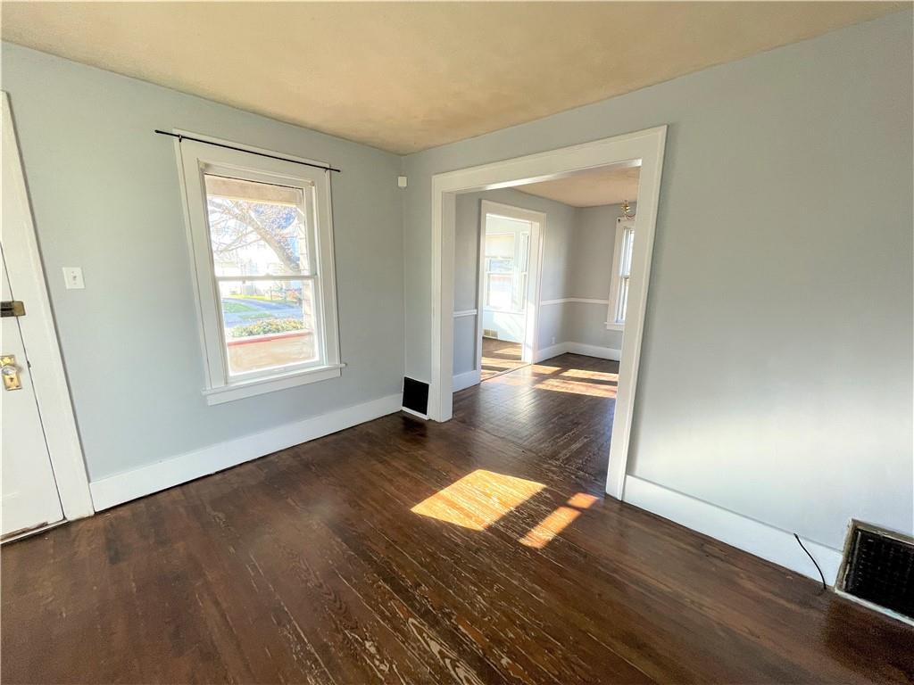 309 East Elizabeth Street New Castle, PA 16105 - Photo 3 of 13 an empty room with wooden floor and windows