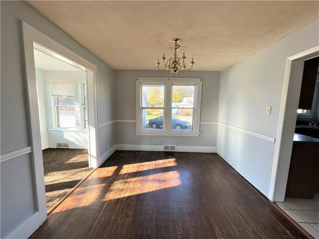 309 East Elizabeth Street New Castle, PA 16105 - Photo 5 of 13 an empty room with wooden floor and windows