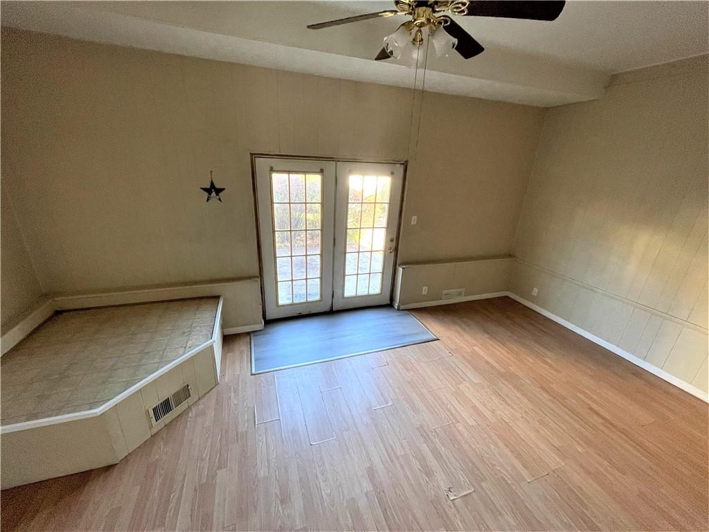 309 East Elizabeth Street New Castle, PA 16105 - Photo 9 of 13 an empty room with wooden floor fan and windows