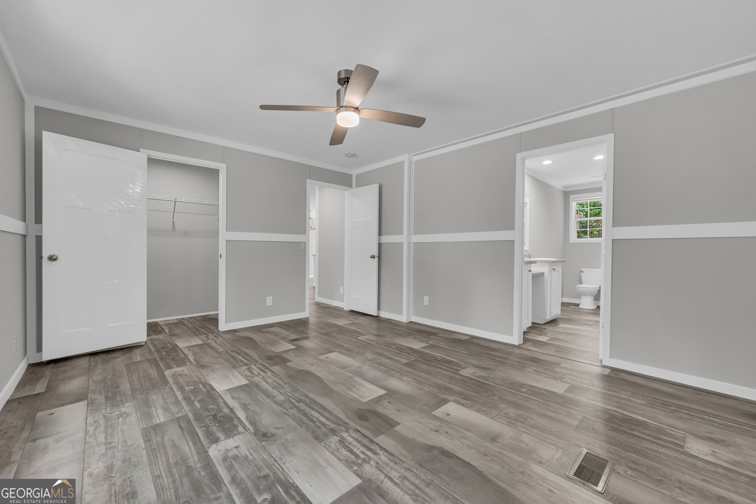 3442 Highway 29 Street South Colbert, GA 30628 - Photo 30 of 39 an empty room with wooden floor chandelier fan and windows