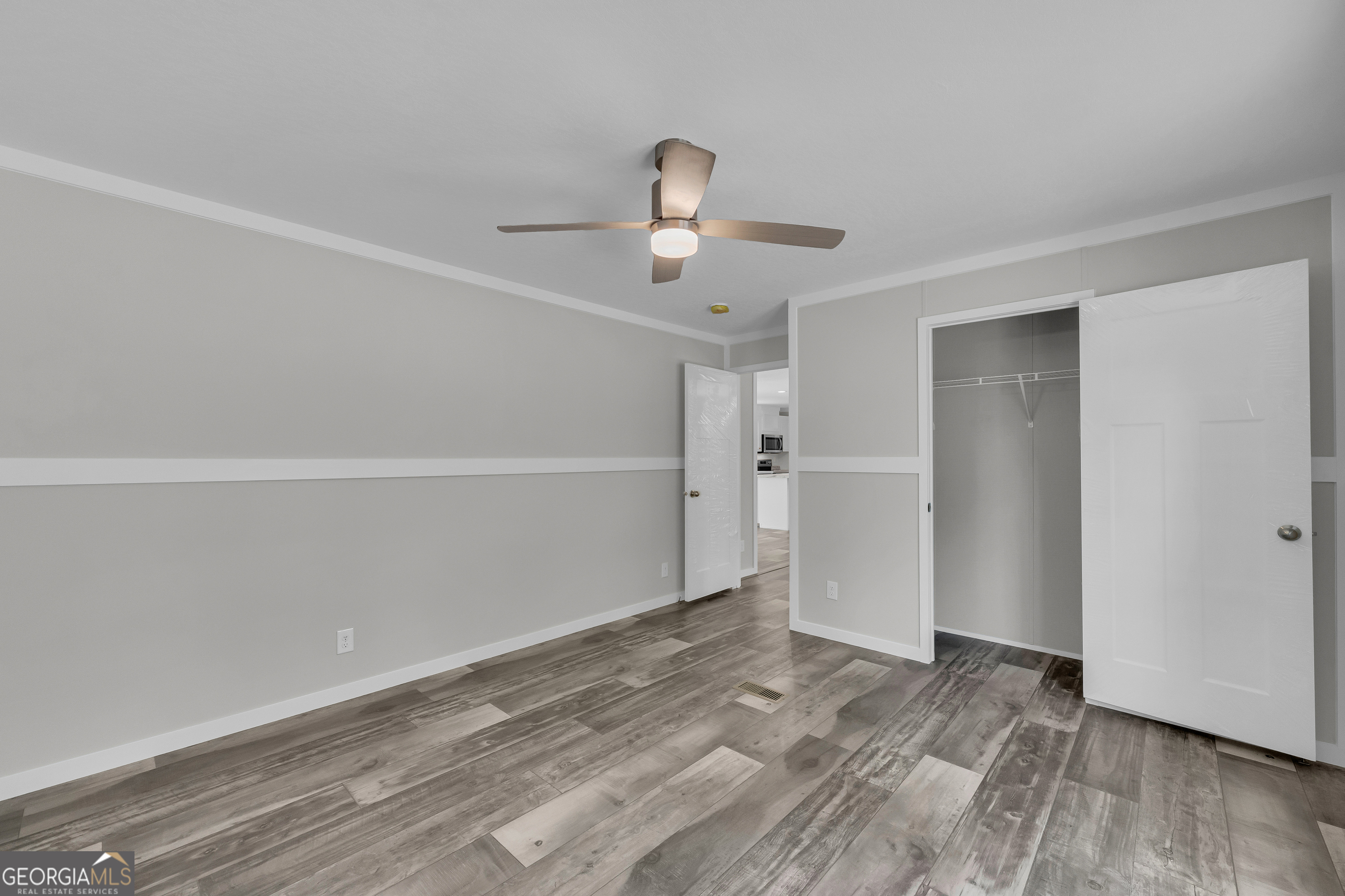 3442 Highway 29 Street South Colbert, GA 30628 - Photo 36 of 39 a view of empty room with wooden floor and ceiling fan