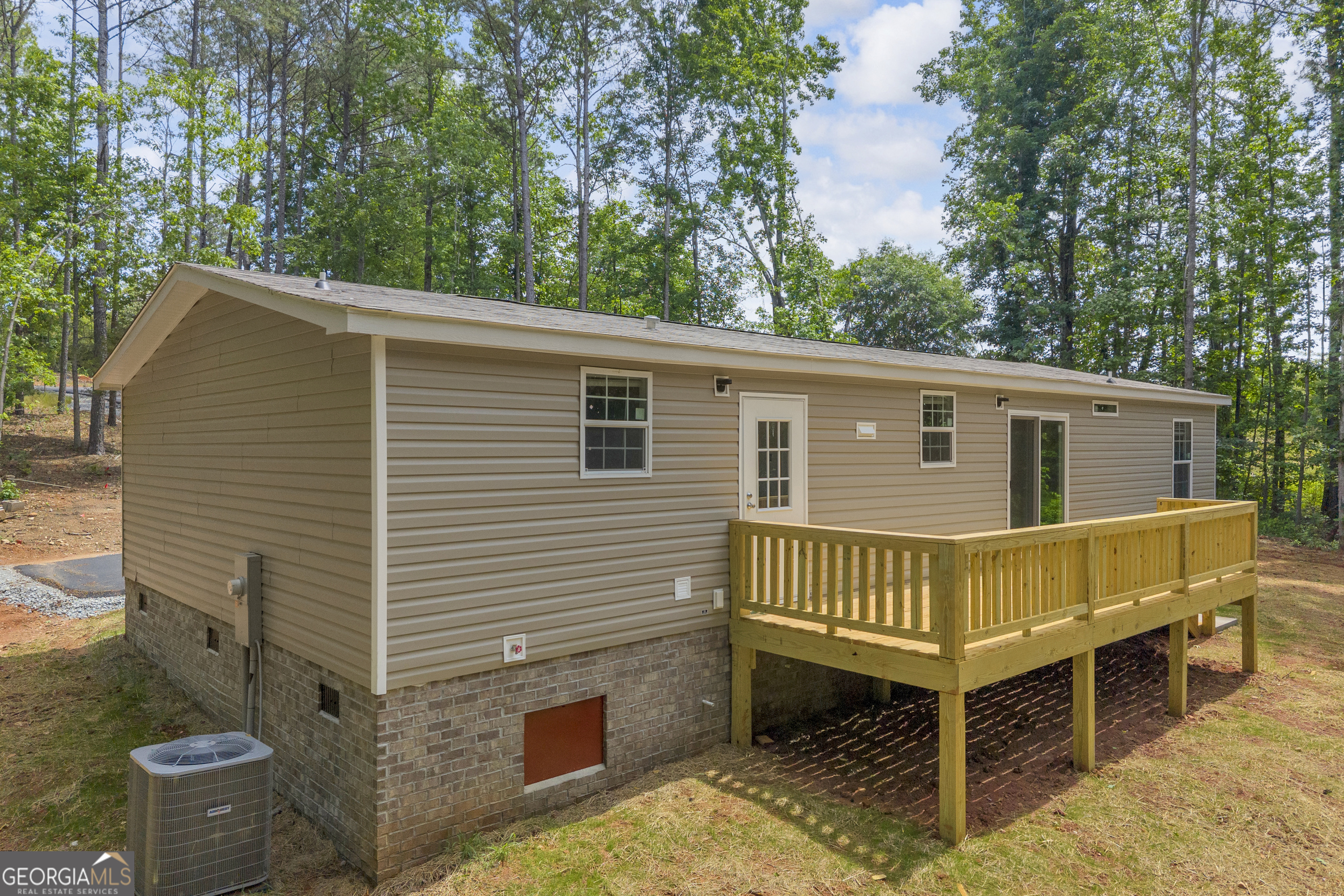 3442 Highway 29 Street South Colbert, GA 30628 - Photo 8 of 39 a view of a house with a wooden deck and a yard