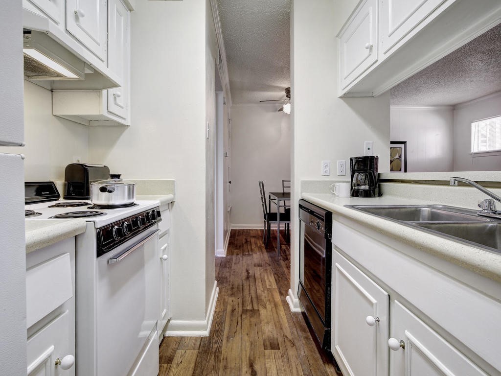 4539 Guadalupe Street, Unit A207 Austin, TX 78751 - Photo 17 of 31 a kitchen with a stove and a sink