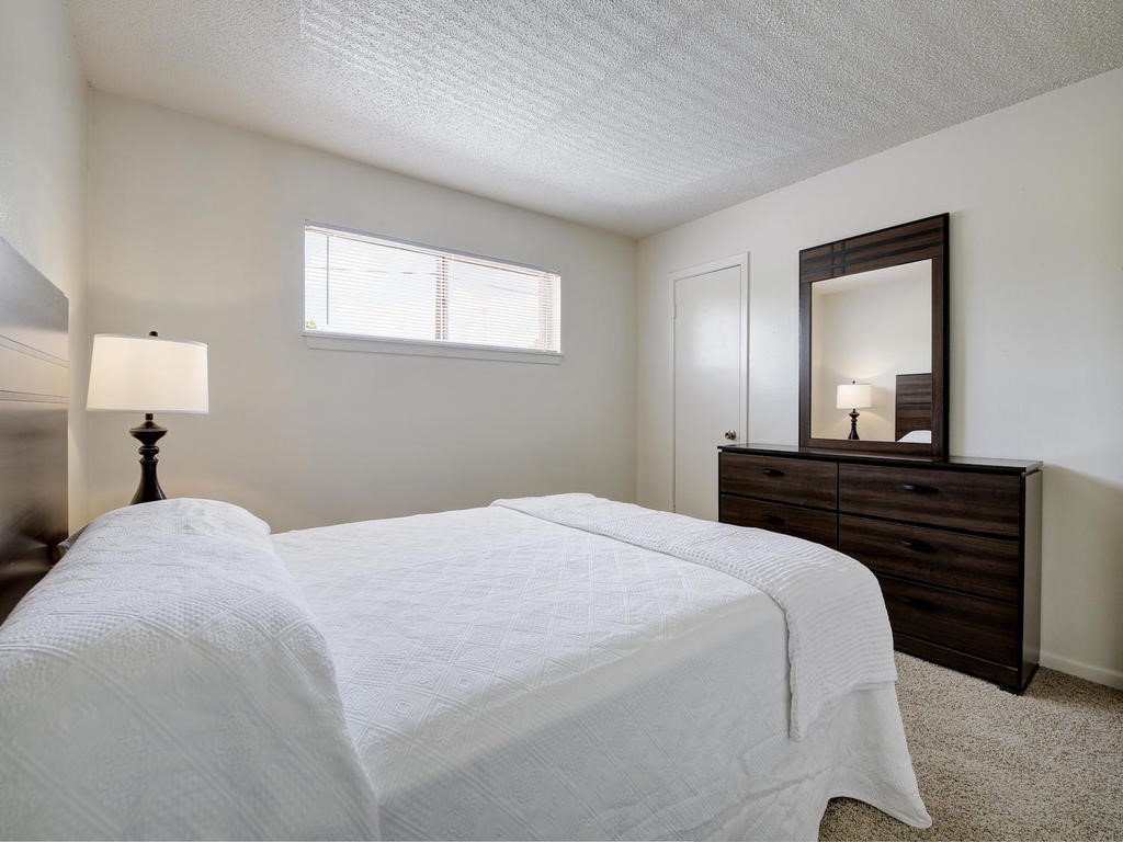 4539 Guadalupe Street, Unit A207 Austin, TX 78751 - Photo 22 of 31 a bedroom with a bed and a mirror
