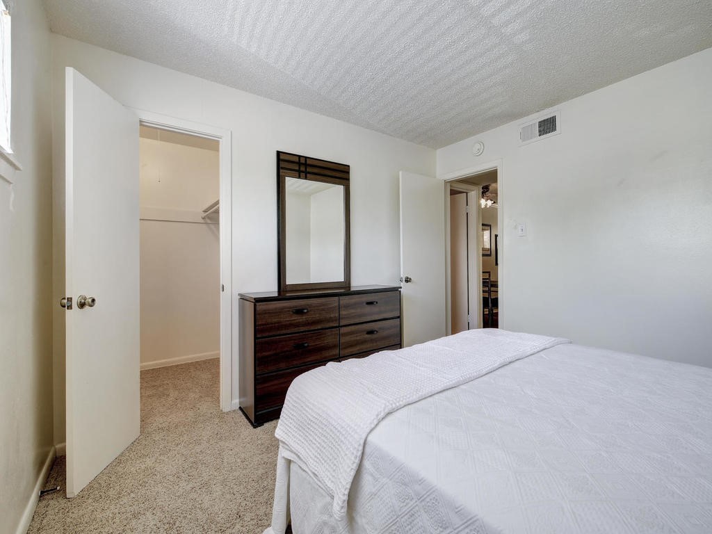 4539 Guadalupe Street, Unit A207 Austin, TX 78751 - Photo 24 of 31 a bedroom with a bed and a mirror
