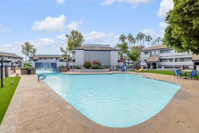 a view of a backyard with a garden and entertaining space