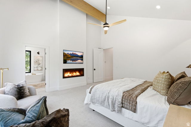 3027 Homestead Road Park City, UT 84098 - Photo 24 of 62 Spacious room featuring vaulted ceilings with exposed wood beams, a sleek linear fireplace, and an integrated ceiling fan