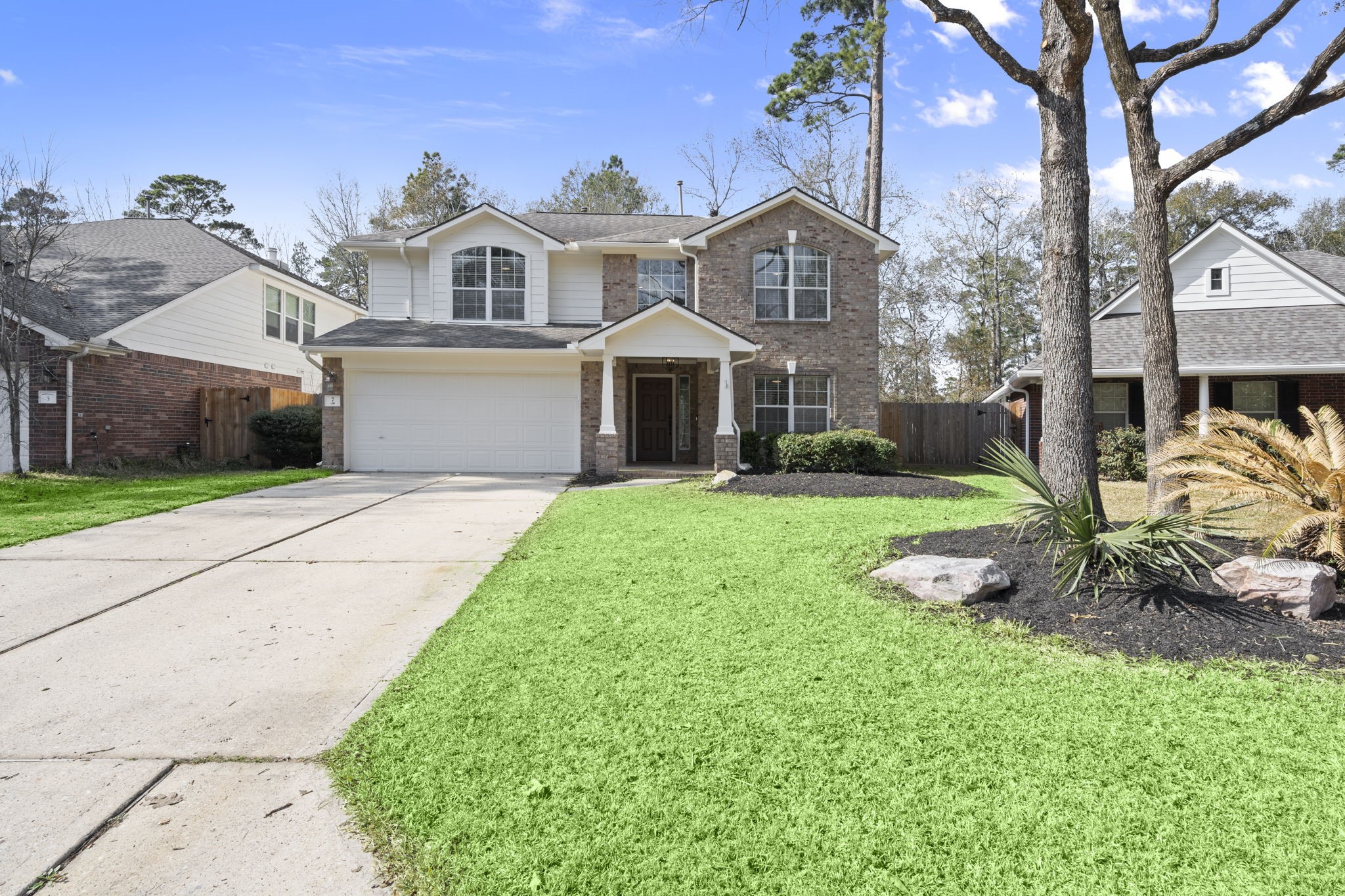 7 Delta Mill Court Conroe, TX 77385 - Photo 1 of 25 a front view of a house with a yard