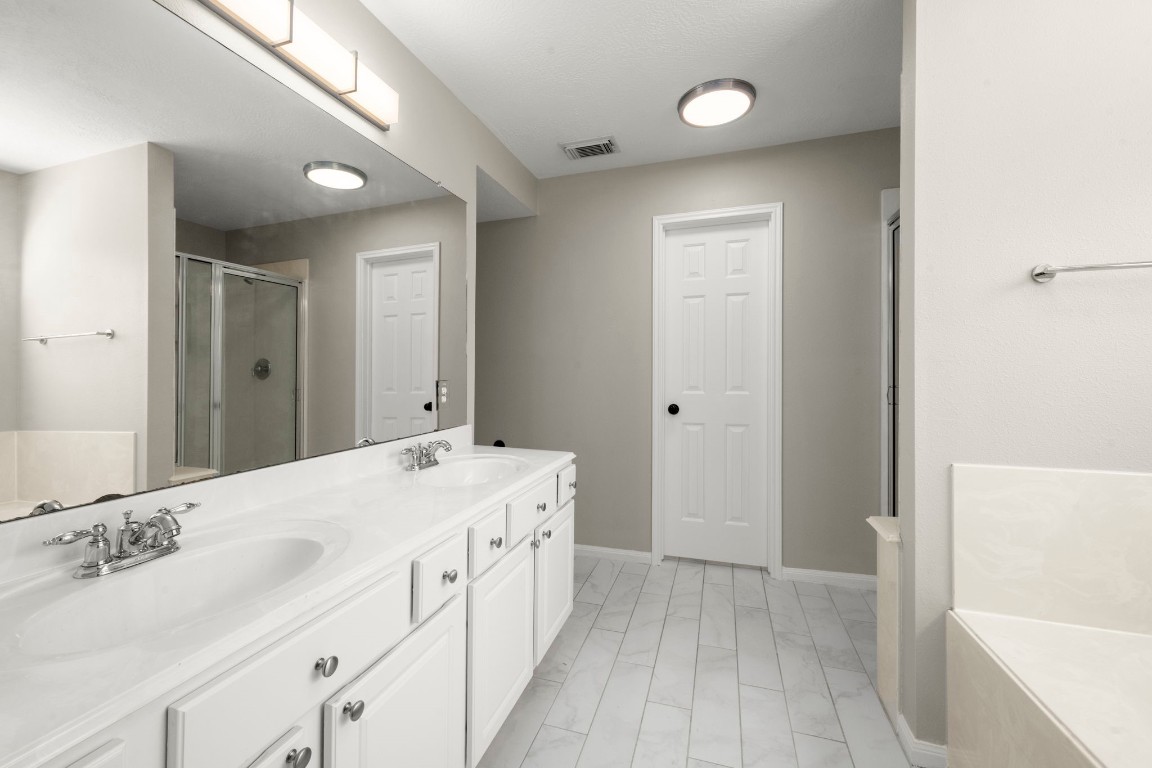 7 Delta Mill Court Conroe, TX 77385 - Photo 13 of 25 a spacious bathroom with a tub sink and mirror