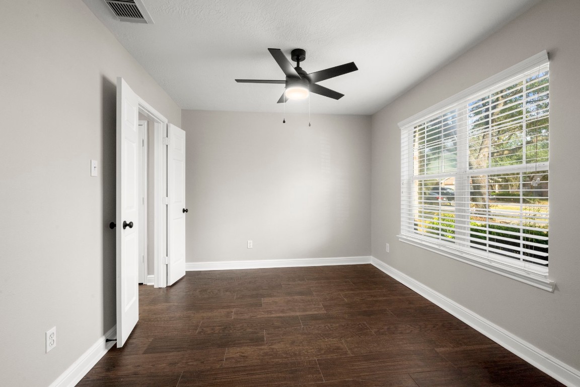7 Delta Mill Court Conroe, TX 77385 - Photo 16 of 25 a view of an empty room with wooden floor and a window