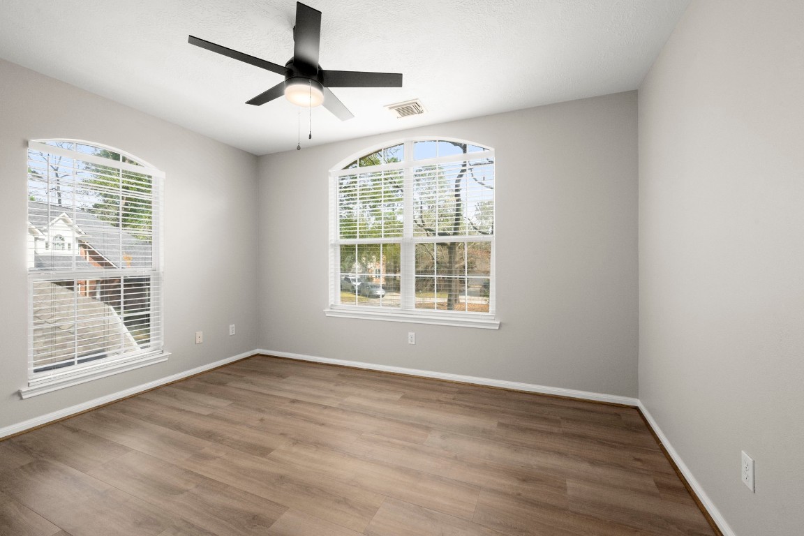 7 Delta Mill Court Conroe, TX 77385 - Photo 20 of 25 a view of an empty room with wooden floor and a window