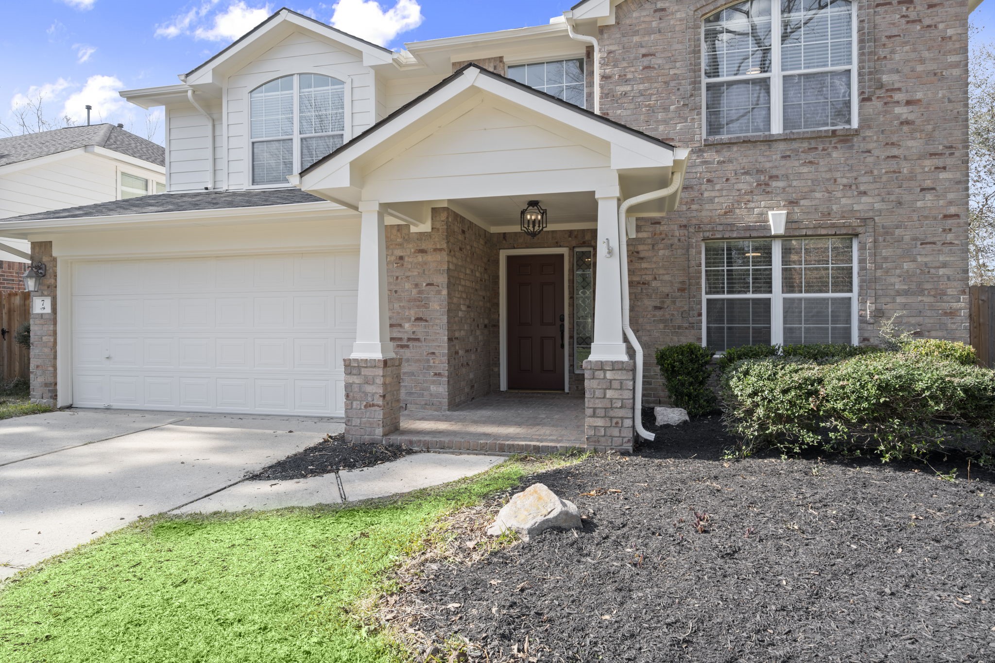 7 Delta Mill Court Conroe, TX 77385 - Photo 2 of 25 a front view of a house with garden