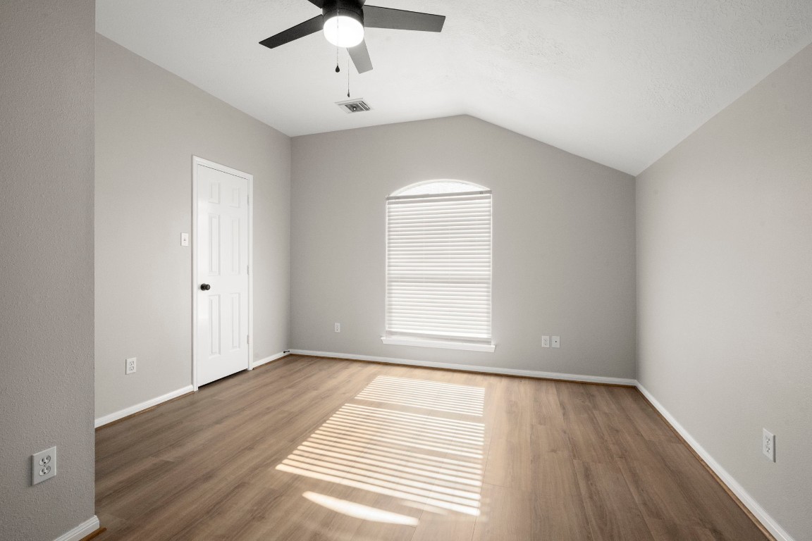7 Delta Mill Court Conroe, TX 77385 - Photo 21 of 25 wooden floor in an empty room with a window