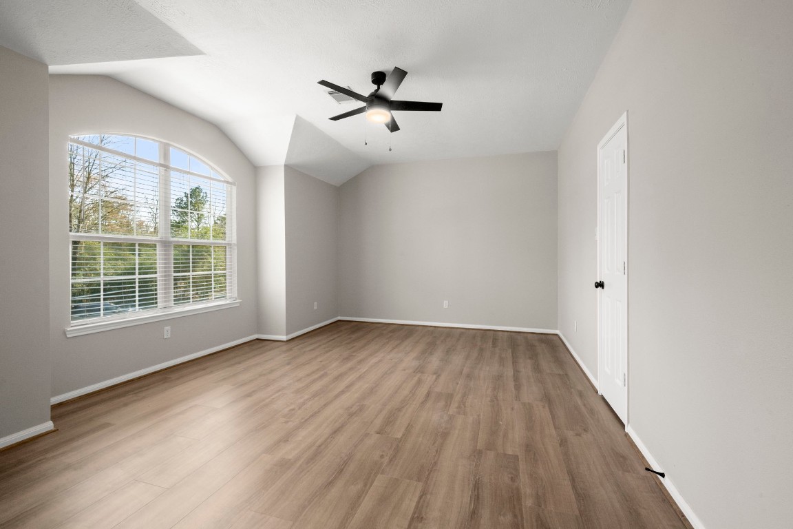 7 Delta Mill Court Conroe, TX 77385 - Photo 22 of 25 wooden floor in an empty room with a window