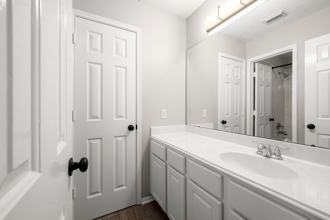 7 Delta Mill Court Conroe, TX 77385 - Photo 23 of 25 a bathroom with a sink and a mirror