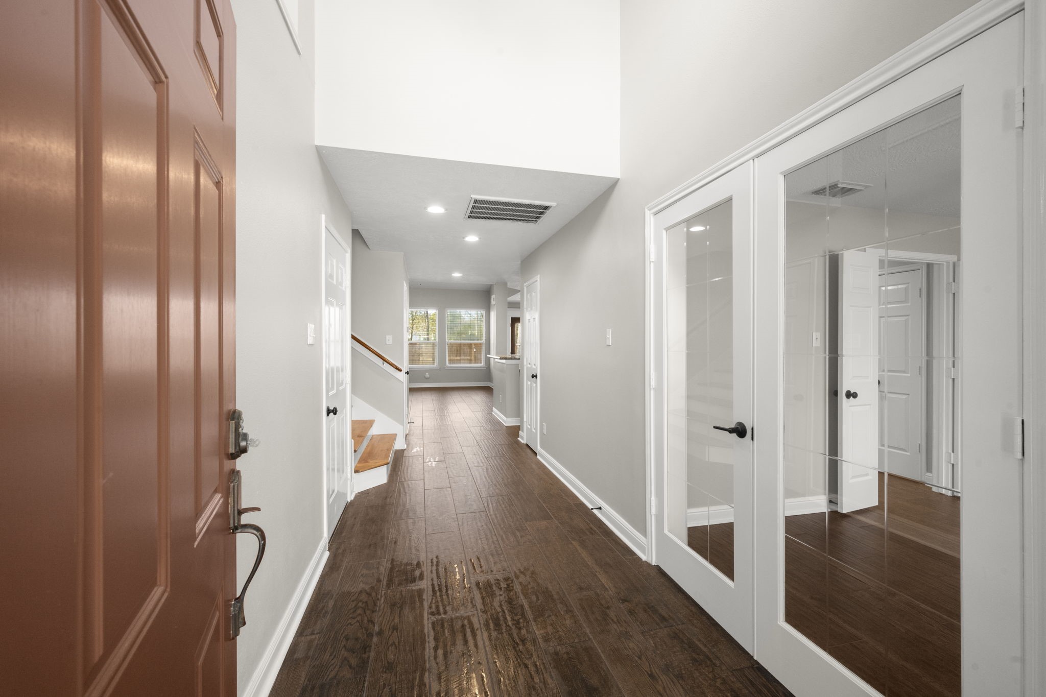 7 Delta Mill Court Conroe, TX 77385 - Photo 3 of 25 a view of a hallway with wooden floor