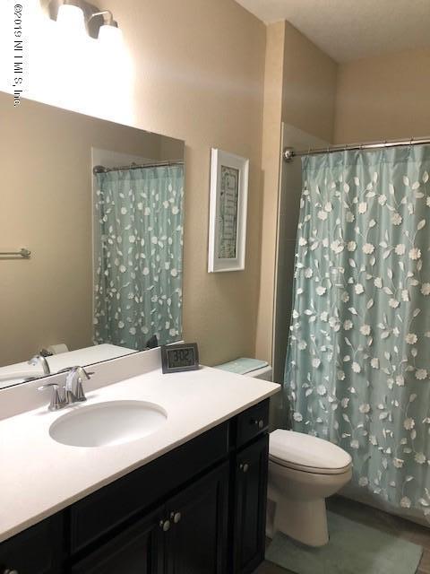 188 Antilles Road St. Augustine, FL 32092 - Photo 14 of 43 a bathroom with a double vanity sink toilet and a mirror