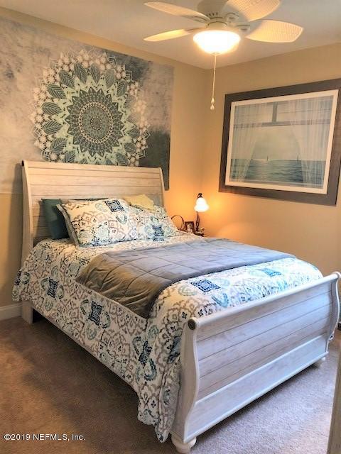 188 Antilles Road St. Augustine, FL 32092 - Photo 18 of 43 a bedroom with a bed and painting on the wall